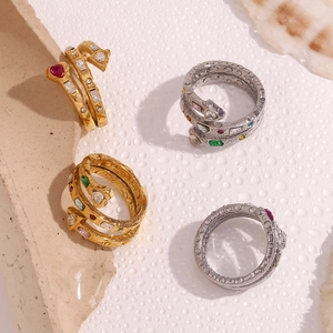 Detailed view of snake-shaped rings with heart-shaped gemstones and zircon inlays