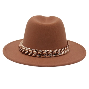 Close-up of brown wool felt fedora hat featuring a chunky gold acrylic chain decoration