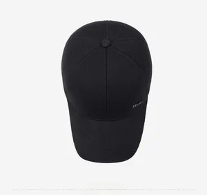 Top view of men's black winter baseball cap showing wool fabric texture and metal sport label