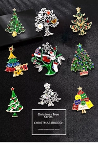 Detailed close-up of 9-piece Christmas tree brooch set with rhinestones and enamel finish