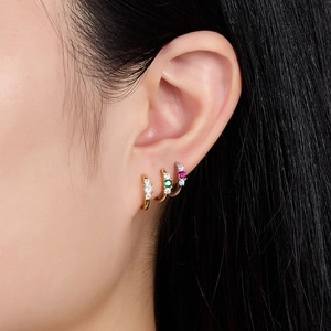 925 silver hoop earrings with colorful zircons worn in a stylish stacked ear arrangement