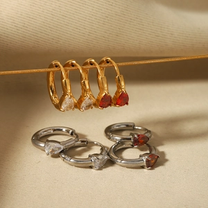 Detailed view of pear-cut heart zircon earrings in 18K gold and silver finishes