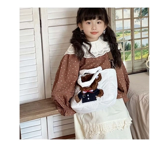 Detailed view of kids white quilted shoulder bag featuring a cute 3D plush bear mascot