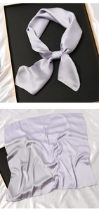Detail of light purple square silk scarf with elegant satin finish on white background