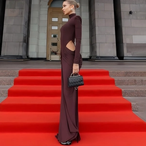 Detail of side cutout on high neck long sleeve maxi dress in deep brown fabric