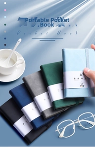 Close-up of A7 mini pocket notebooks with elastic bands in professional assorted colors