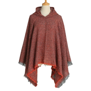 Orange knit hooded poncho cape with tweed pattern and dark tassel fringe detail