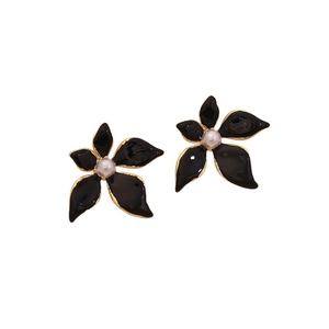 Elegant black flower stud earrings with gold edges and pearl centers on white background