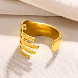 Macro shot of gold-plated open ring featuring a minimalist palm hugging design and smooth finish