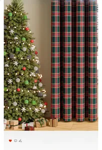 Detail of red and green plaid Christmas curtain beside a decorated holiday tree