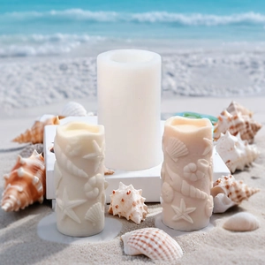 Detail view of cylindrical silicone mold with sea shell patterns on a sandy beach