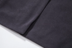Detailed macro shot of dark grey wool blend fabric with premium woven twill texture