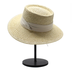 Detailed close-up showing the natural woven texture and ribbon of the straw boater hat