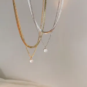 Double-layered gold and silver snake chain necklaces with minimalist zircon pendants