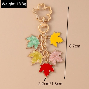 Detail of colorful maple leaf pendant keychain with enamel finish and size dimensions