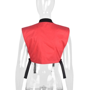 Detail view of red cropped utility vest with black stand collar and adjustable side straps