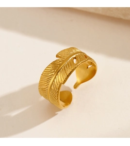 Detailed view of golden feather ring showing intricate leaf textures and adjustable open band