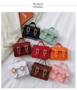 Flat lay of mini glossy jelly satchel bags in eight colors with golden chain straps