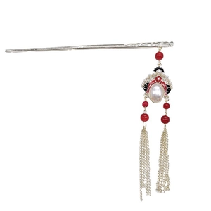 Elegant Chinese vintage hair pin with red pearls and long gold tassels on white background