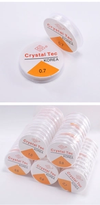 Macro shot of Crystal Tec clear elastic string rolls for DIY jewelry and beading crafts