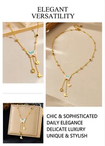 Detail of gold butterfly tassel necklace with colorful enamel pendants and fluid chain charms