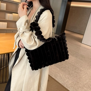 Large black plush tote bag with spherical shoulder strap and gold hardware accents