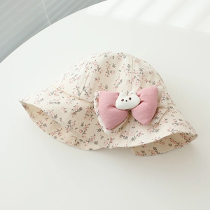 Detail of floral baby sun hat with pink bow and 3D bunny ornament for outdoor travel
