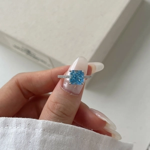 Close-up of s925 silver ring featuring a square blue zircon and pavé-set stones