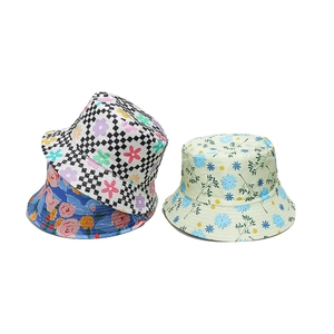 Close-up of floral bucket hats with daisy and checkerboard patterns for beach wear