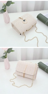 Close-up of beige woven crossbody bag with gold chain strap and elegant hardware details