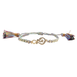 Detailed shot of infinity star charm on colorful woven bracelet with long silk tassels
