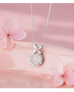Macro shot of S925 silver necklace featuring a white agate stone and zircon butterfly