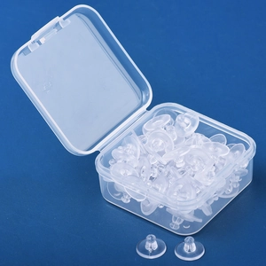 Clear plastic earring backings and round silicone pads with a transparent storage box