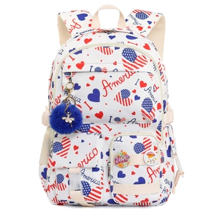 Detailed front view of white backpack with America patterns and blue pom-pom charm