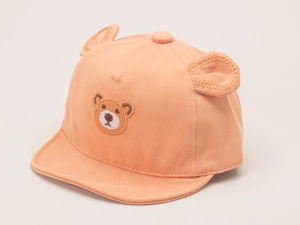 Detail of light orange cotton baby cap with bear embroidery and 3D animal ears