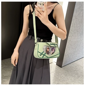 Light green ita bag featuring traditional knot closure and transparent window display