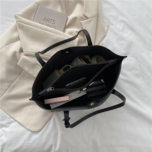 Black large capacity soft leather tote bag with internal compartments and zipper divider
