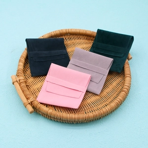Microfiber velvet jewelry pouches in four colors presented in a woven basket