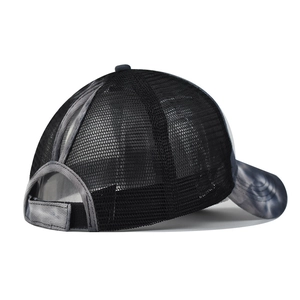 Detail of breathable mesh back and ponytail hole on black marble tie-dye sun hat