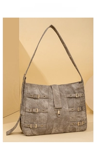 Detail of vintage brown tote bag with metal buckles and durable wide shoulder strap