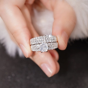 Macro shot of 2-piece luxury zircon wedding ring set with six-prong solitaire and pavé bands