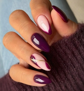 Detail of long almond press-on nails with purple gradients and golden wavy line accents