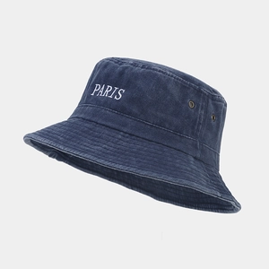 Close-up of white PARIS embroidery on vintage washed blue cotton bucket hat with eyelets