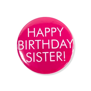 Detail of a bright rose pink Happy Birthday Sister tinplate badge with shiny metallic finish