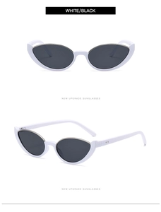 Detail view of white cat-eye sunglasses with silver metal trim and dark lenses