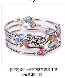 Detail of bohemian multilayer wrap bracelet with colorful emperor stones and floral charms