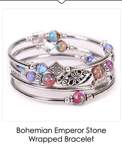 Detail of bohemian multilayer wrap bracelet with colorful emperor stones and floral charms