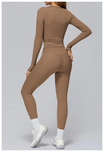 Detail view of high waist yoga leggings and long sleeve top in brown athletic fabric