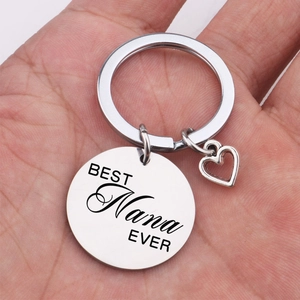 Polished silver heart keychain with BEST Nana EVER engraving held in hand