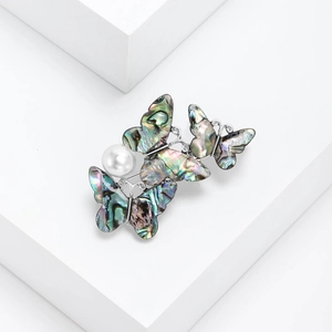 Elegant silver alloy butterfly brooch with natural abalone shell wings and pearl accents